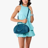 Planetary Small | Model holding a half circle crossbody bag with handles and removable crossbody strap 