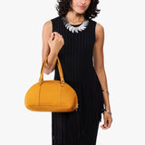 Sunshine Small | Model holding a half circle crossbody bag with handles and removable crossbody strap 