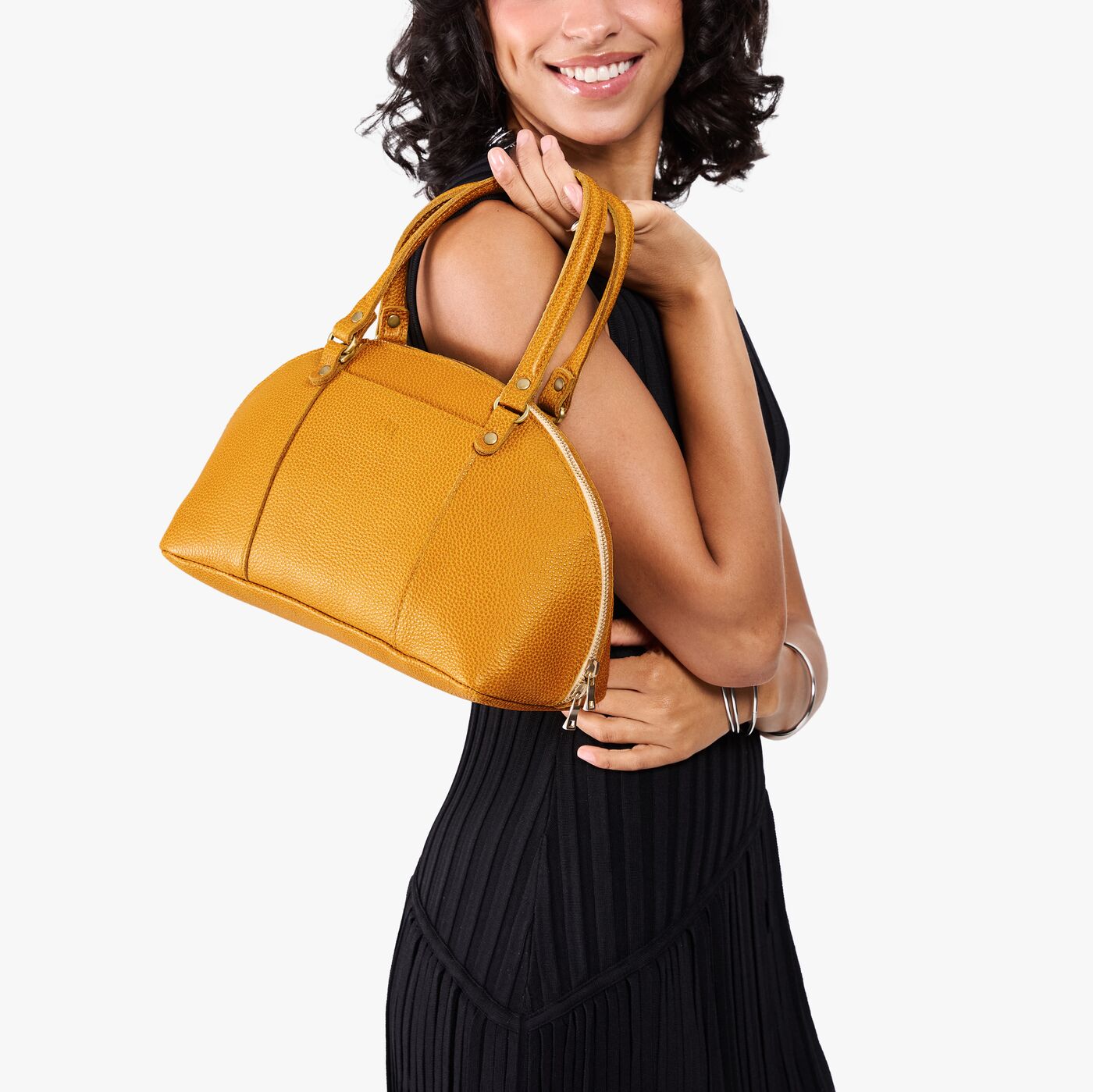 Sunshine*Small | Model holding a half circle crossbody bag with handles and removable crossbody strap 