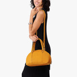 Sunshine Small | Model holding a half circle crossbody bag with handles and removable crossbody strap 