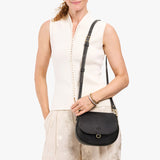 Full Moon Small | Model wearing a leather Crossbody with a flap and magnetic closure