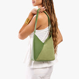 Dryland Green Small | Model carrying petite shoulder bag with adjustable strap and magnetic snap closure