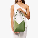 Dryland Green Small | Model holding petite shoulder bag with adjustable strap and magnetic snap closure