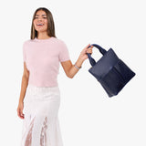 Cobalt Small | Model wearing a convertible tote clutch crossbody