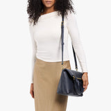 Night Owl Small | Model wearing a convertible tote clutch crossbody