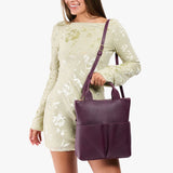 Plum Small | Model wearing a convertible tote clutch crossbody