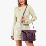 Plum Small | Model wearing a convertible tote clutch crossbody