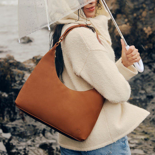 Model wearing Jackson Willow Shoulder Bags on Beach in the rain
