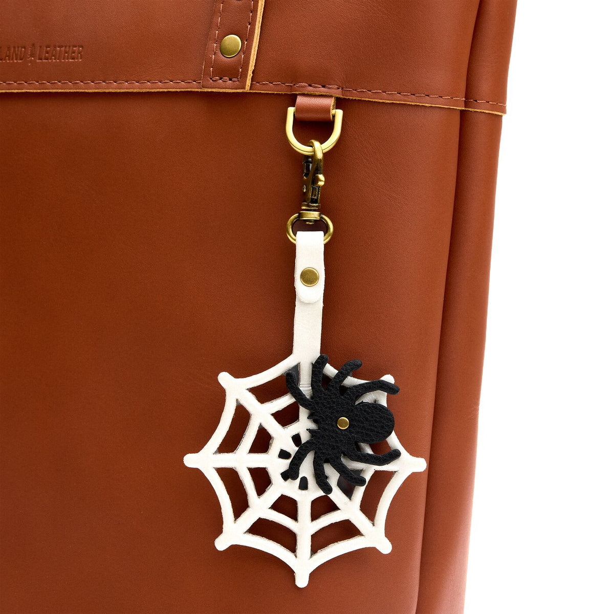 Spider Web | Spiderweb shaped leather keychain with a black spider on top