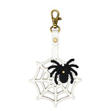 Spider Web | Spiderweb shaped leather keychain with a black spider on top