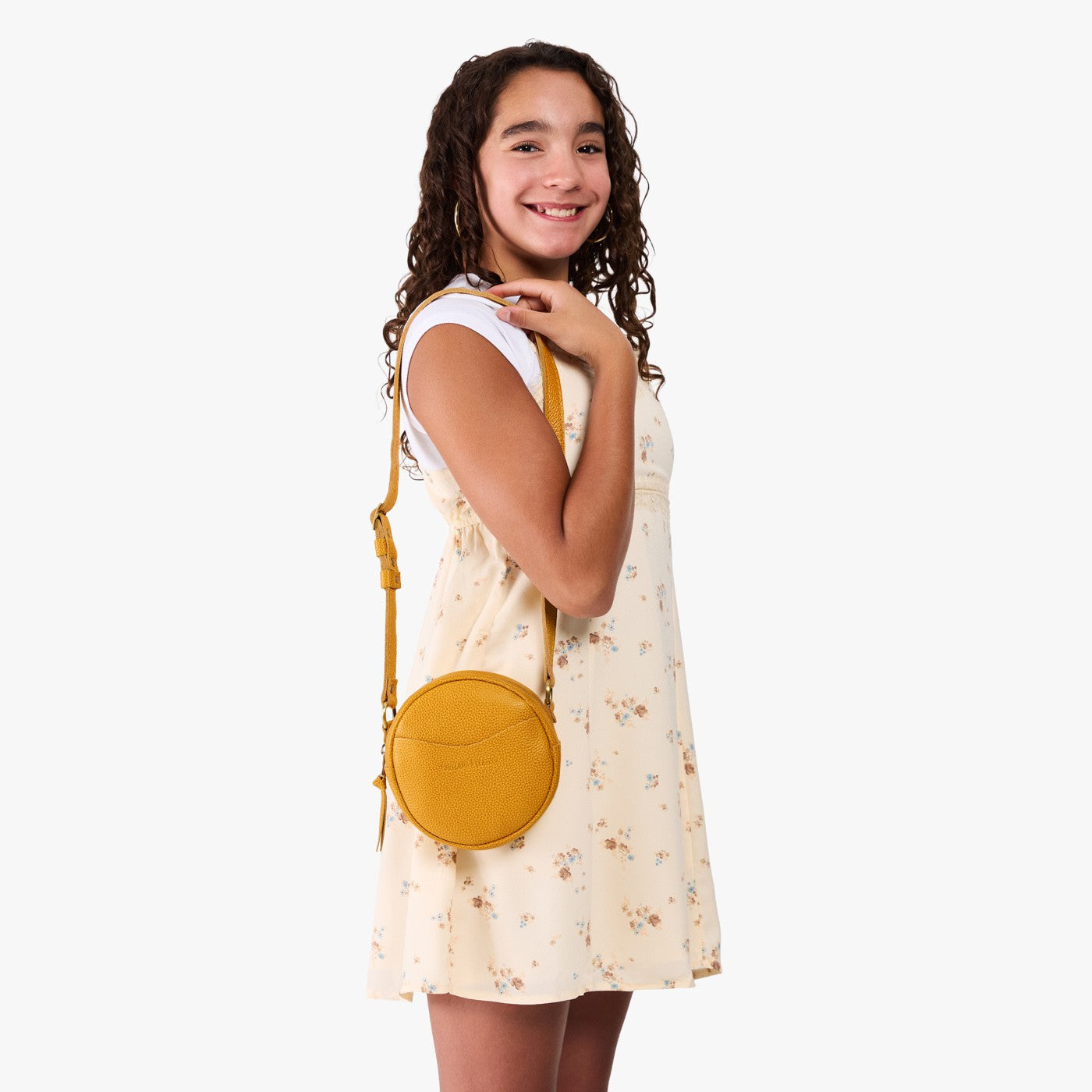 Sunshine | Model wearing a circle shaped crossbody bag with top zipper and gold accents