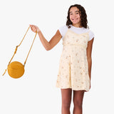 Sunshine | Model wearing a circle shaped crossbody bag with top zipper and gold accents