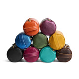 All Variants | Collection of cylindrical leather pouches with zippers and handles
