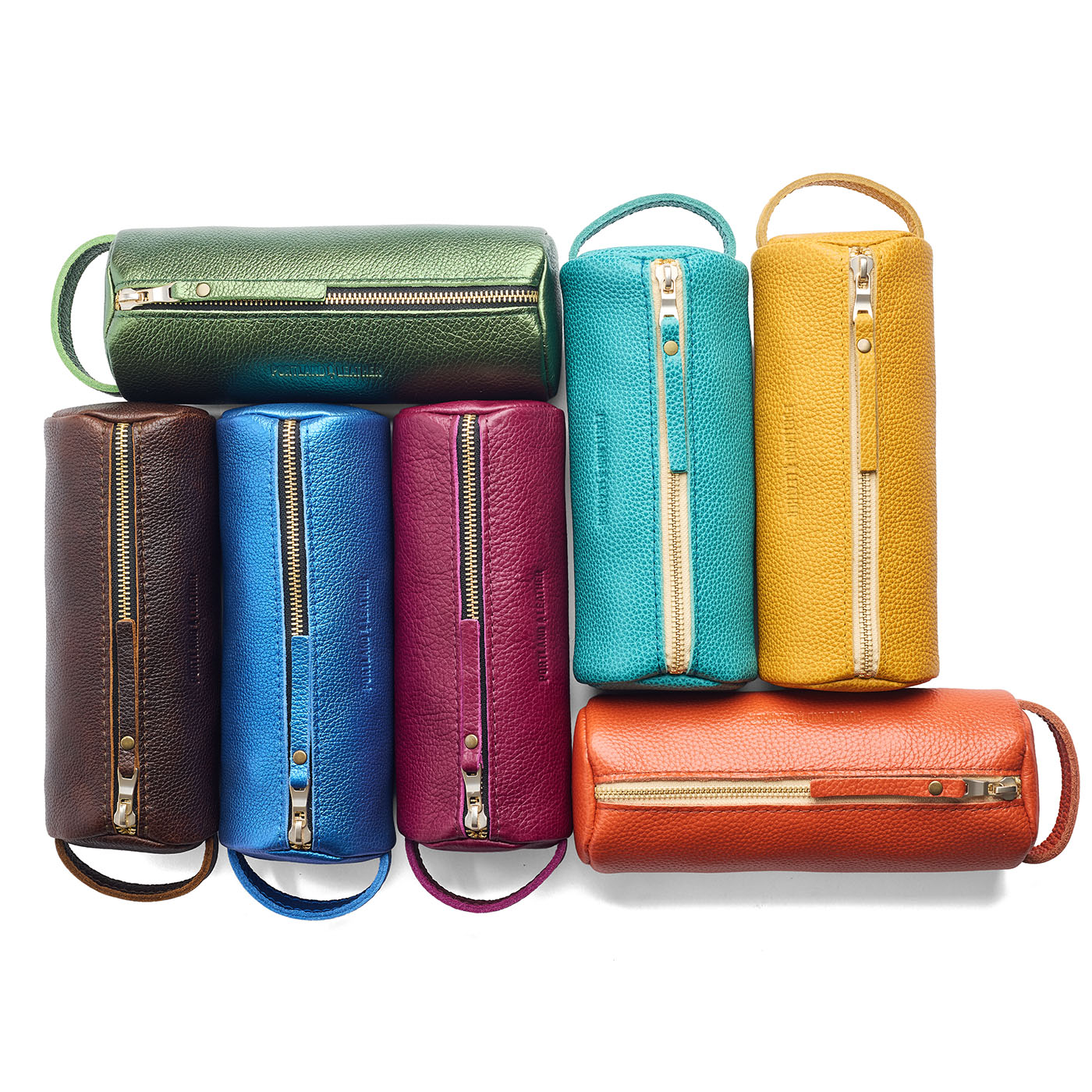 All Variants | Collection of cylindrical leather pouches with zippers and handles