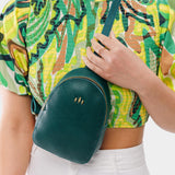 Sea Glass | Model wearing small sling bag with zipper closure and adjustable strap