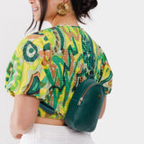 Sea Glass | Model wearing small sling bag with zipper closure and adjustable strap