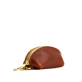 Nutmeg | Taco shaped leather pouch with zipper and swivel lobster clasp on white background