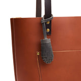 Full Moon | Pom-pom style with tiered leather fringe hanging from a leather tote bag