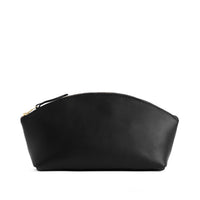 Black*Total Eclipse | Spacious leather makeup bag with curved seams and top zipper