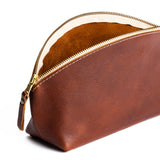 Nutmeg | Spacious leather makeup bag with curved seams and top zipper open