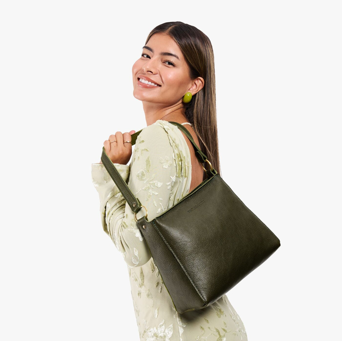Pebbled Olive*Small | Model holding a triangular shoulder bag with antiqued brass finished 