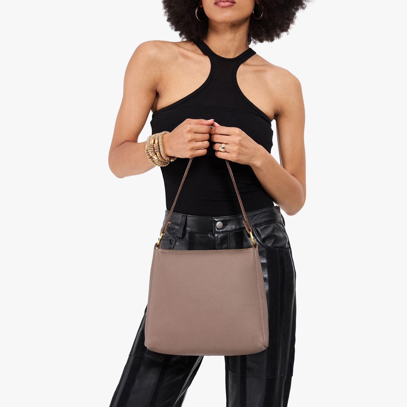 Sparrow*Small | Model holding a triangular shoulder bag with antiqued brass finished 