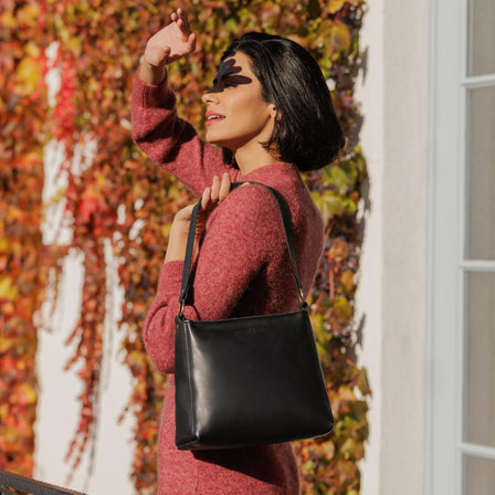 Black | Triangular shoulder bag with antiqued brass finished hardware