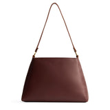 Cognac Large | Large triangular shoulder bag with antiqued brass finished hardware