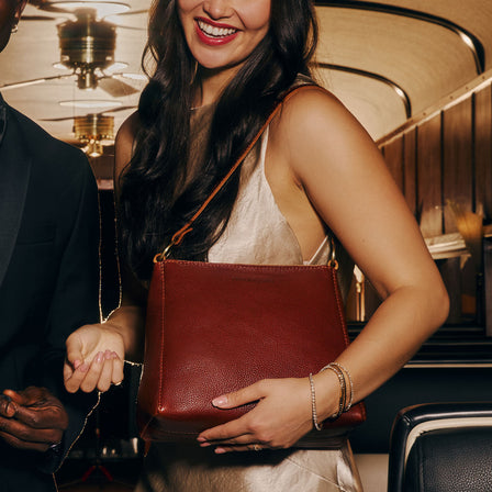 Nutmeg | Triangular shoulder bag with antiqued brass finished hardware