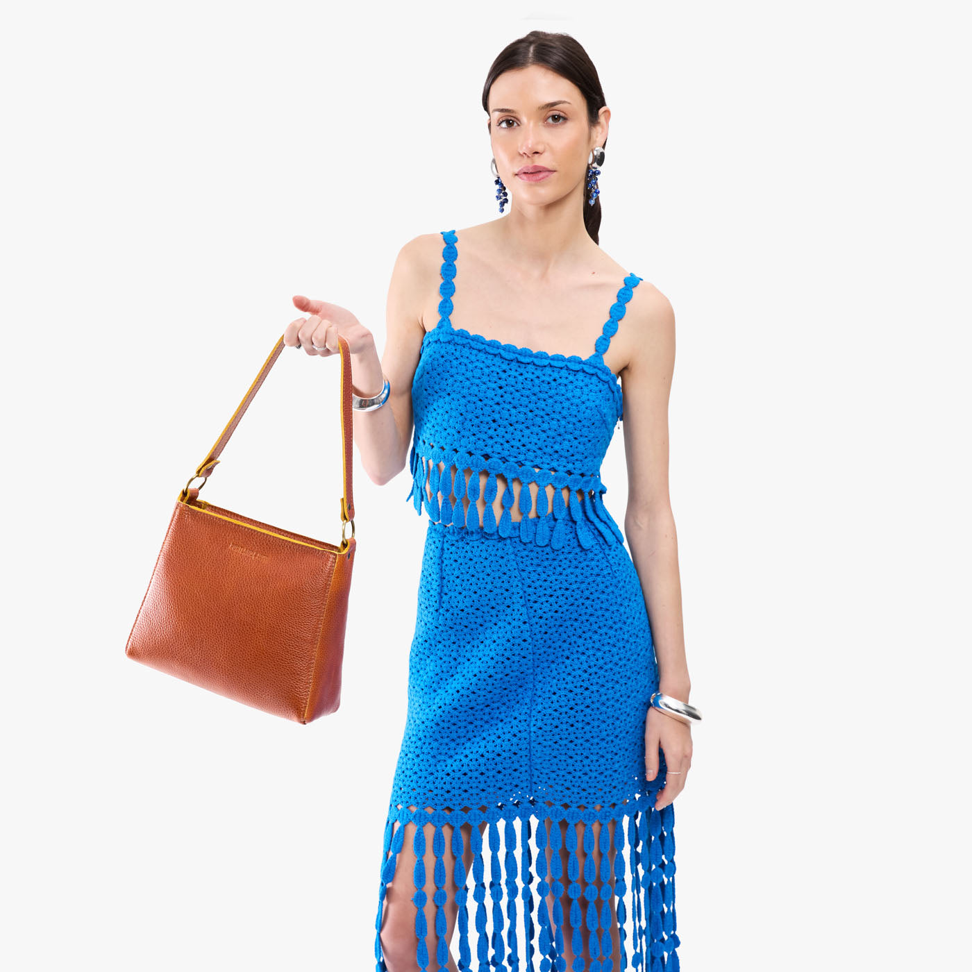 Sienna*Classic | Model holding triangular shoulder bag with antiqued brass finished hardware