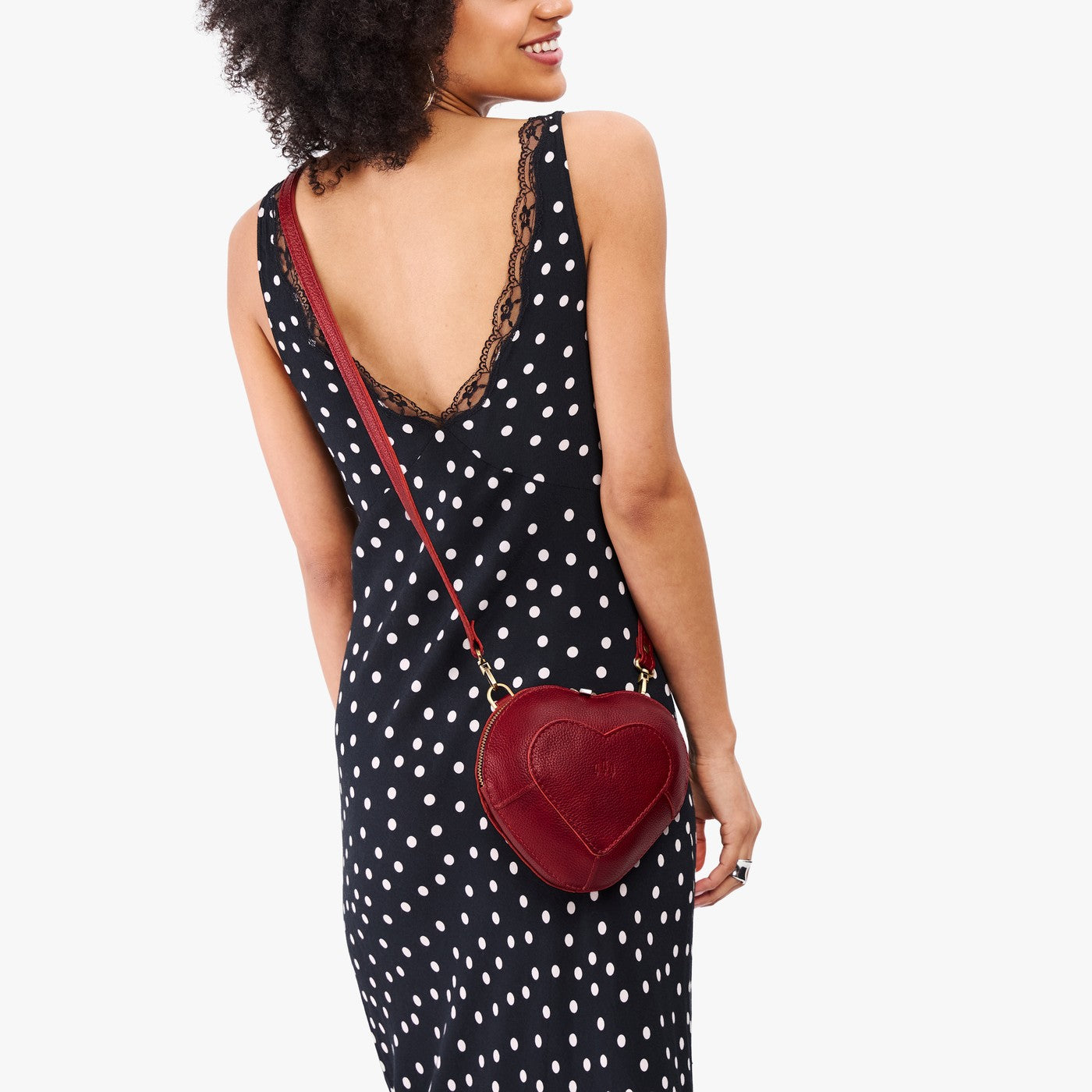 Chili Red | Model wearing heart shaped leather crossbody bag