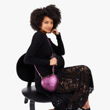 Ultra Violet | Model wearing heart shaped leather crossbody bag
