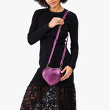 Ultra Violet | Model wearing heart shaped leather crossbody bag