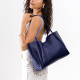 Cobalt Large | Model holding large rectangular tote bag