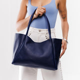 Cobalt Large | Model holding large rectangular tote bag
