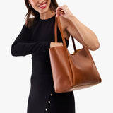 Honey Large | Woman carrying a wide tote with leather straps and snap closure