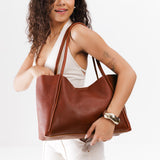 Nutmeg Large | Model holding large rectangular tote bag