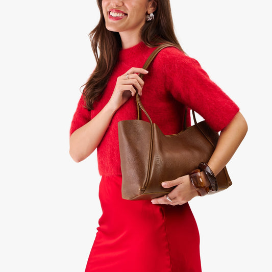 Asheville*Medium | Woman in a red outfit holding wide tote with leather straps and snap closure