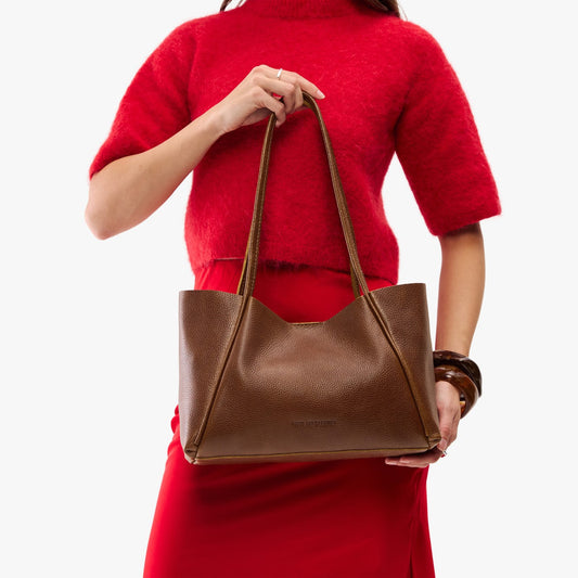 Asheville*Medium | Woman in a red outfit holding wide tote with leather straps and snap closure