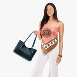 Boreal Medium | Woman carrying a wide tote with leather straps and snap closure