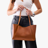 Honey Medium | Woman carrying a wide tote with leather straps and snap closure