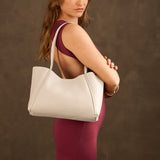 Pebbled Bone Medium | Model holding midsize rectangular tote bag