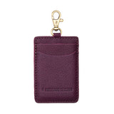 Plum | A leather card holder with a swivel lobster clasp on a white background