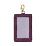 Plum | A leather card holder with a swivel lobster clasp on a white background
