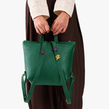Bacalar | Model wearing a petite square slim leather tote backpack with zipper closure and adjustable straps