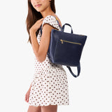 Cobalt | Model wearing a petite square slim leather tote backpack with zipper closure and adjustable straps
