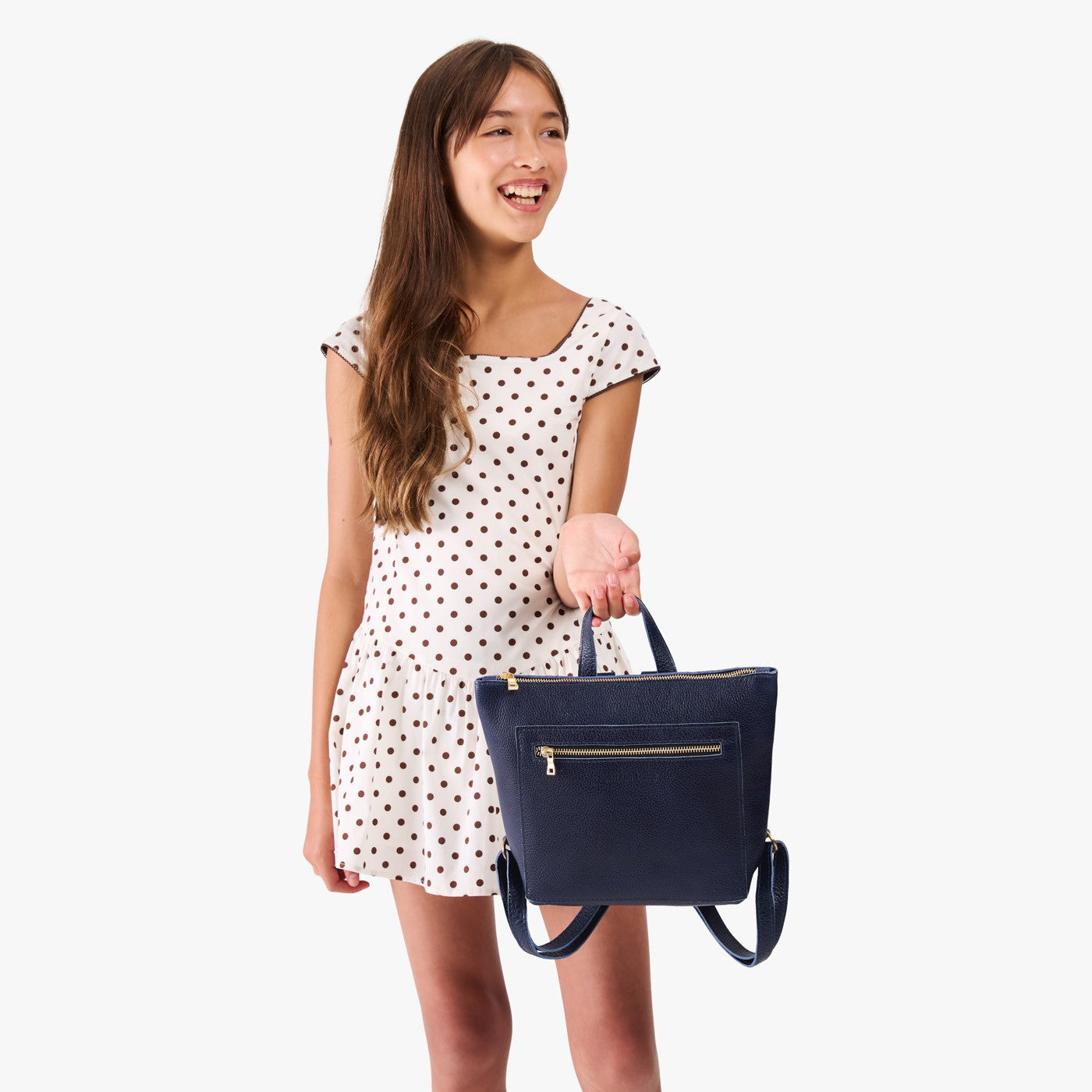 Cobalt | Model wearing a petite square slim leather tote backpack with zipper closure and adjustable straps