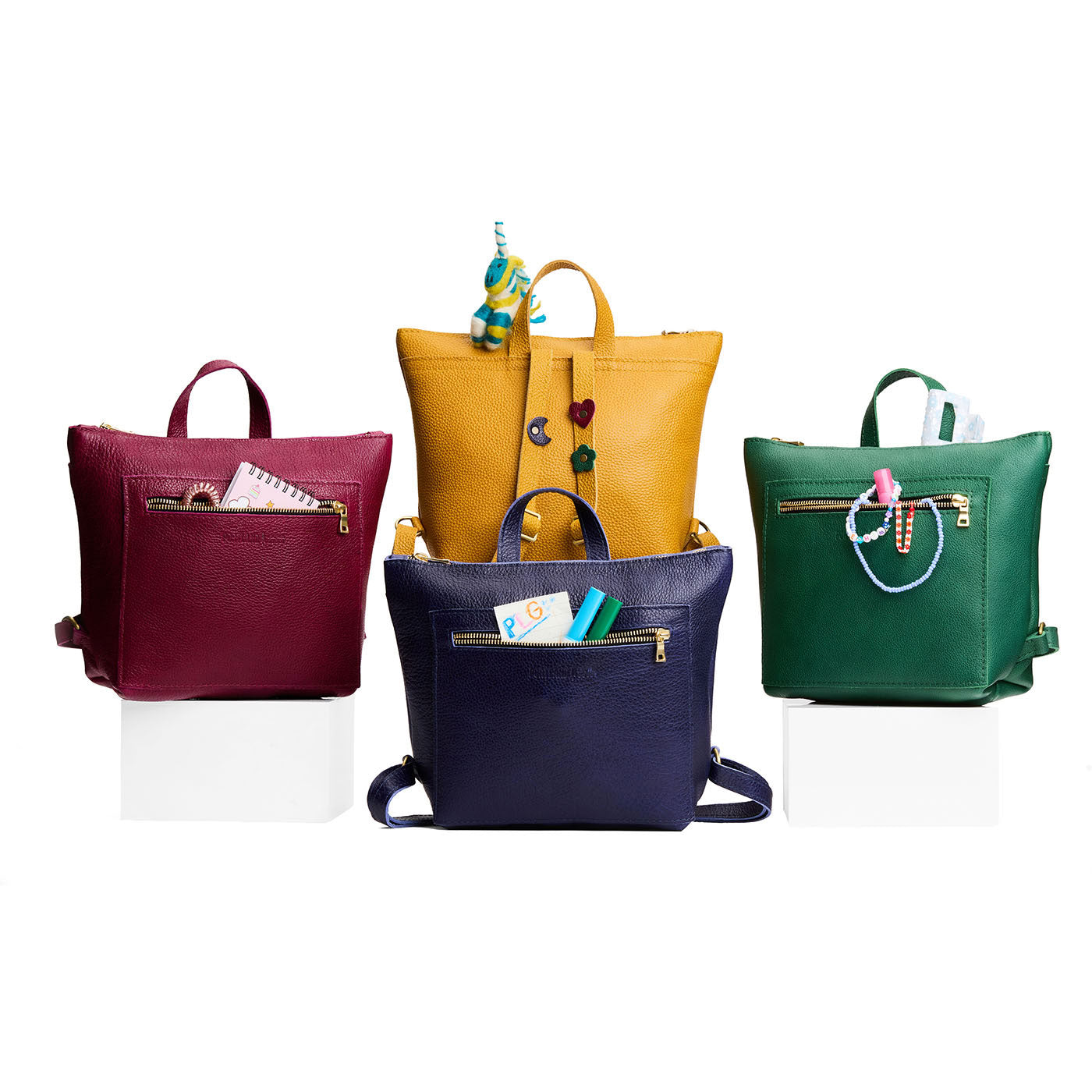All Variants | A group image of 4 petite square slim leather tote backpacks with zipper closures and adjustable straps