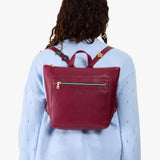 Orchid | Model wearing a petite square slim leather tote backpack with zipper closure and adjustable straps