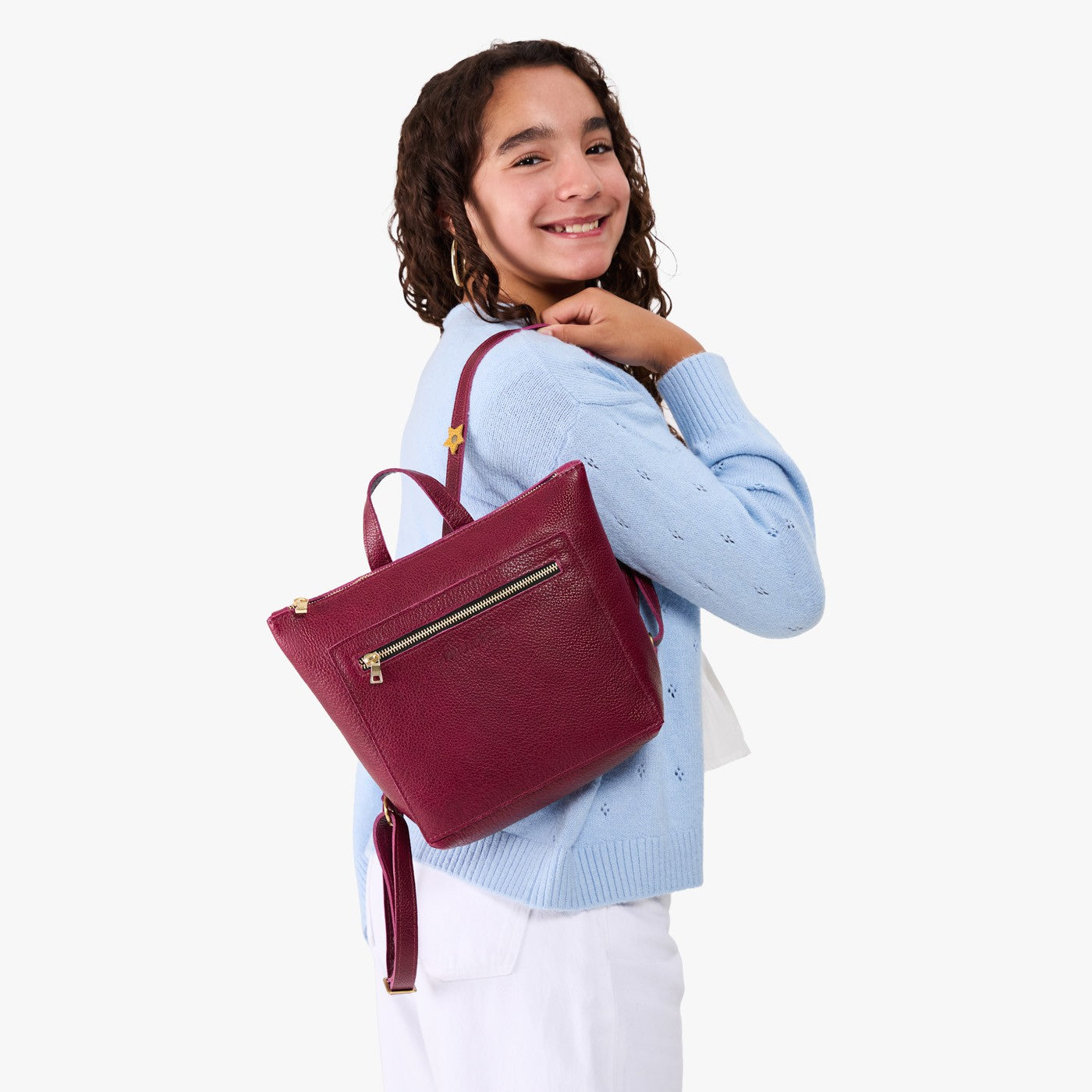 Orchid | Model wearing a petite square slim leather tote backpack with zipper closure and adjustable straps